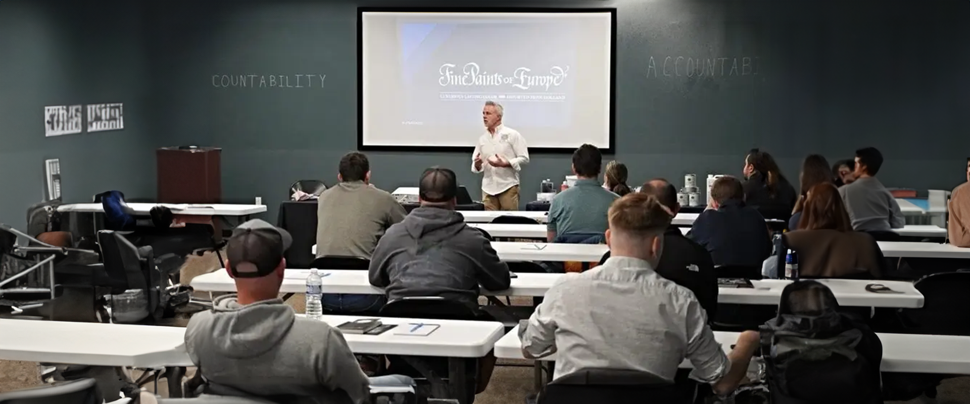 A man standing in front of a class room